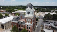 an aerial view of a brick building with a clock tower