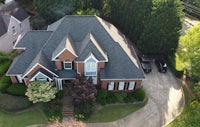 an aerial view of a brick home